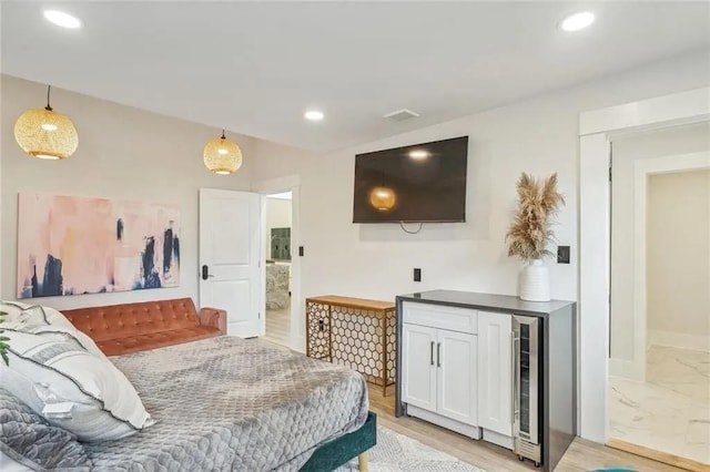 bedroom featuring light hardwood / wood-style flooring and beverage cooler