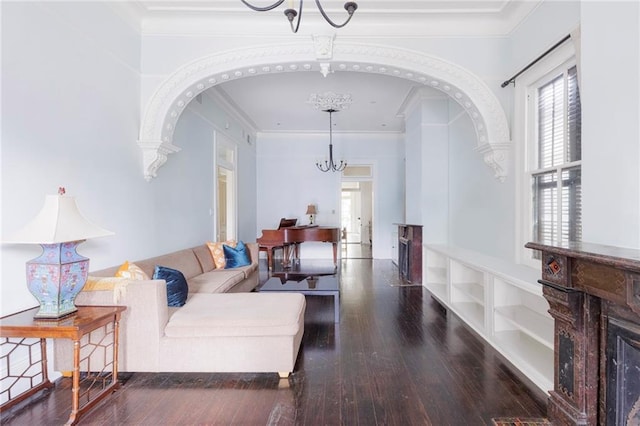 living room featuring built in features, ornamental molding, and dark wood-type flooring