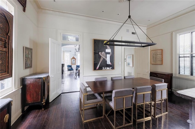 dining area featuring crown molding and dark wood-type flooring