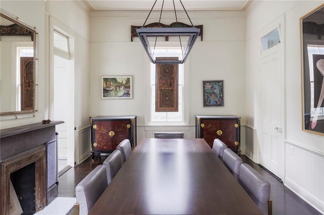 dining space with dark hardwood / wood-style floors and ornamental molding