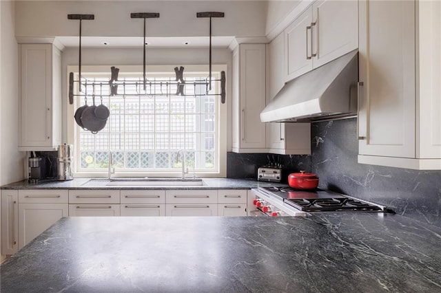 kitchen featuring white cabinets, pendant lighting, and tasteful backsplash