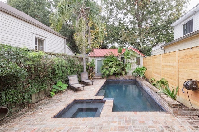 view of swimming pool with an in ground hot tub and a patio