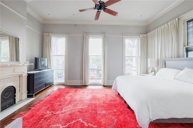 bedroom featuring access to exterior, ceiling fan, crown molding, and hardwood / wood-style floors