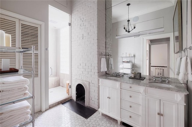 bathroom featuring tile patterned floors, a fireplace, vanity, a shower with shower door, and ornamental molding