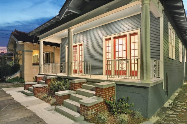 property exterior at dusk with a porch