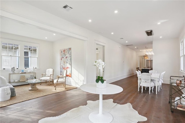 interior space with dark wood-type flooring and an inviting chandelier