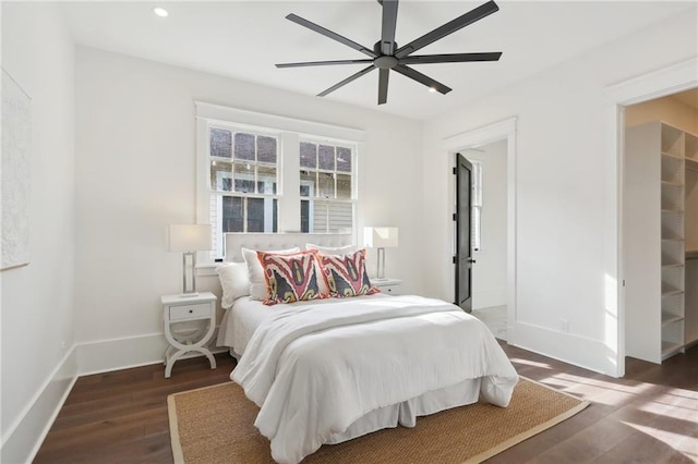 bedroom with ceiling fan and dark hardwood / wood-style flooring