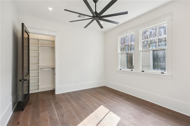 unfurnished bedroom with hardwood / wood-style flooring, ceiling fan, and a closet