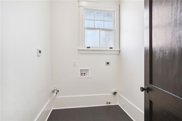 washroom featuring gas dryer hookup, dark tile patterned floors, and hookup for a washing machine