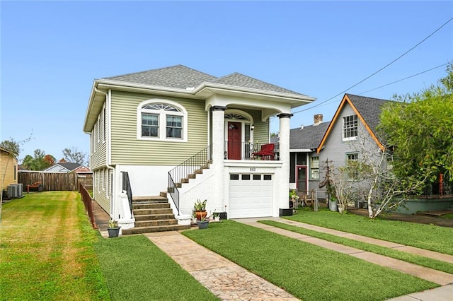 view of front of house with central AC and a front lawn