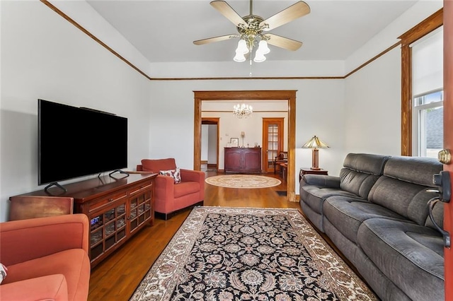 living room with dark hardwood / wood-style floors and ceiling fan with notable chandelier