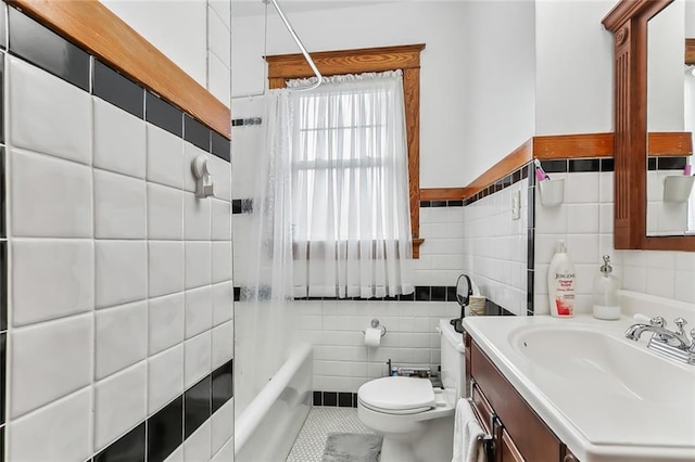 full bathroom featuring vanity, shower / bathtub combination with curtain, tile walls, tile patterned flooring, and toilet