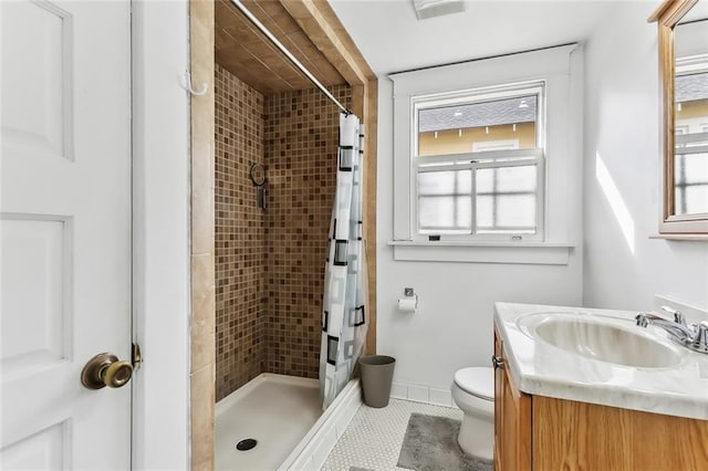 bathroom with tile patterned floors, vanity, curtained shower, and toilet