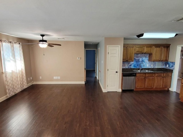 kitchen with dishwasher, tasteful backsplash, dark wood-type flooring, and sink