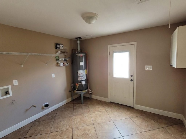 laundry room with cabinets, hookup for a gas dryer, gas water heater, washer hookup, and light tile patterned flooring