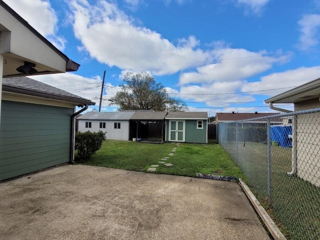 view of yard featuring a patio area and a storage shed