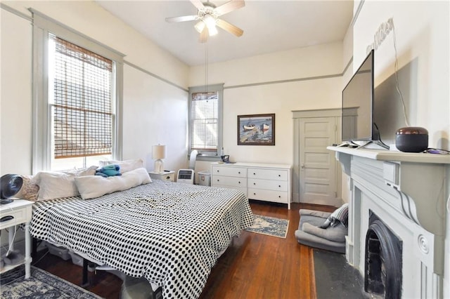 bedroom with ceiling fan and dark hardwood / wood-style flooring