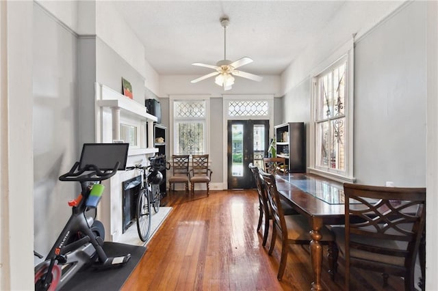 dining area featuring hardwood / wood-style floors, ceiling fan, and french doors