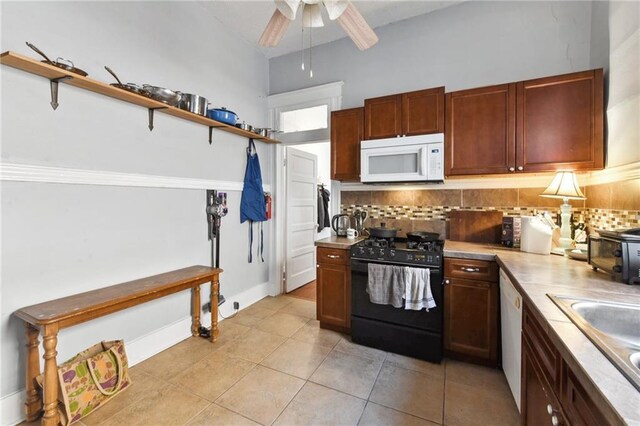 kitchen with light tile patterned flooring, sink, ceiling fan, white appliances, and backsplash