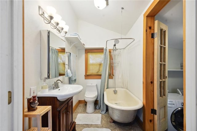 full bathroom with vaulted ceiling, washer / dryer, shower / bath combination with curtain, vanity, and toilet