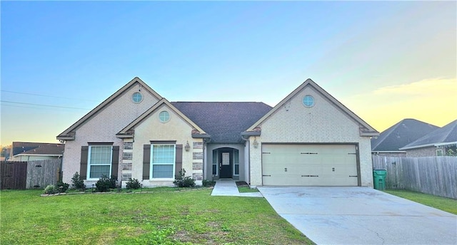 view of front facade with a yard and a garage