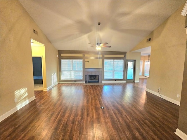 unfurnished living room with ceiling fan, dark hardwood / wood-style flooring, a fireplace, and lofted ceiling