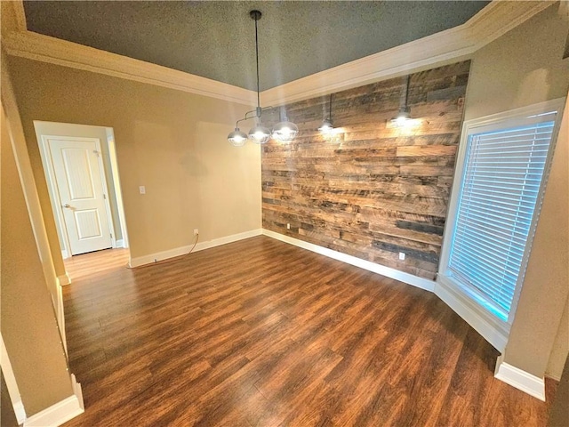 unfurnished dining area with crown molding, dark hardwood / wood-style floors, and a textured ceiling