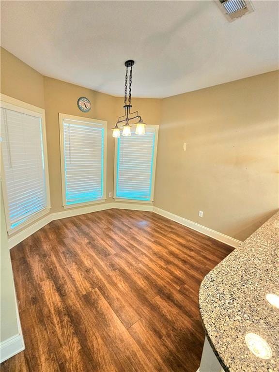 unfurnished dining area with dark hardwood / wood-style floors