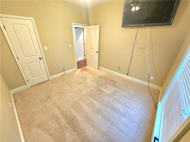 unfurnished bedroom with light colored carpet