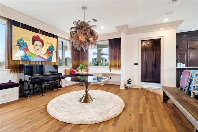 misc room with a chandelier, light hardwood / wood-style flooring, and ornamental molding