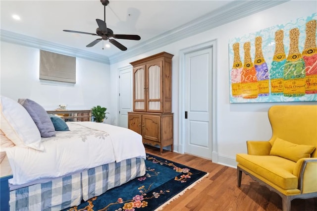 bedroom featuring light hardwood / wood-style flooring, ceiling fan, and crown molding