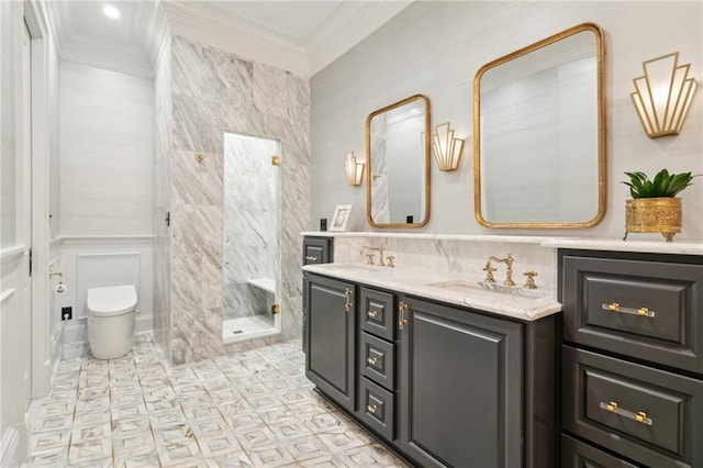 bathroom with tiled shower, vanity, toilet, and ornamental molding