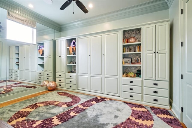 interior space with ceiling fan and crown molding