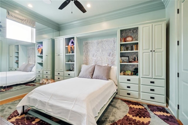 bedroom featuring ceiling fan, hardwood / wood-style floors, and ornamental molding