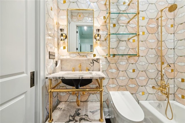 bathroom featuring a bath, vanity, and toilet