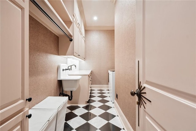 bathroom with washing machine and dryer and crown molding