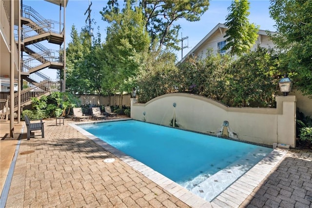 view of swimming pool featuring a patio area