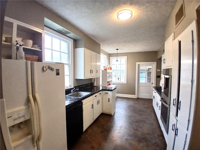 kitchen featuring white cabinetry, white fridge with ice dispenser, and dishwasher