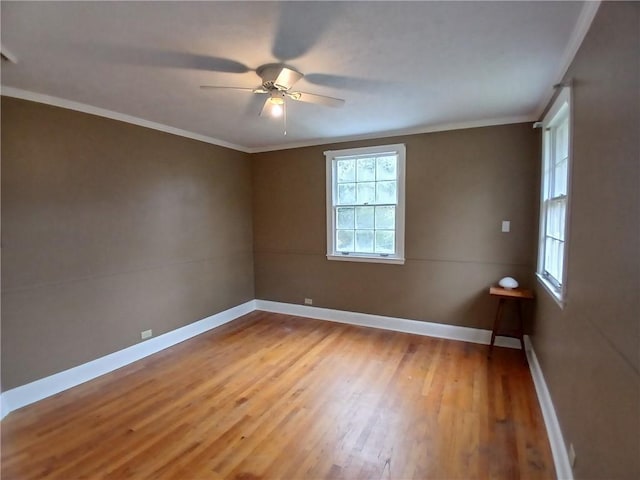 empty room featuring hardwood / wood-style floors, ceiling fan, and ornamental molding