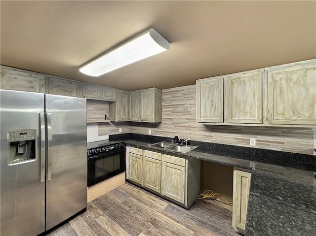 kitchen featuring backsplash, dark wood-type flooring, black appliances, sink, and dark stone countertops