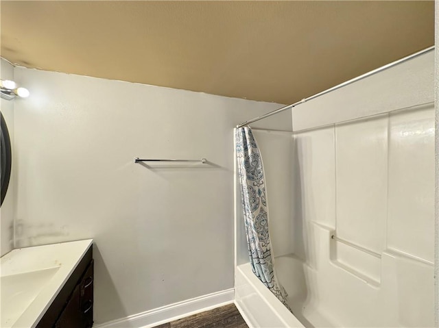 bathroom featuring vanity, hardwood / wood-style flooring, and shower / bath combo with shower curtain