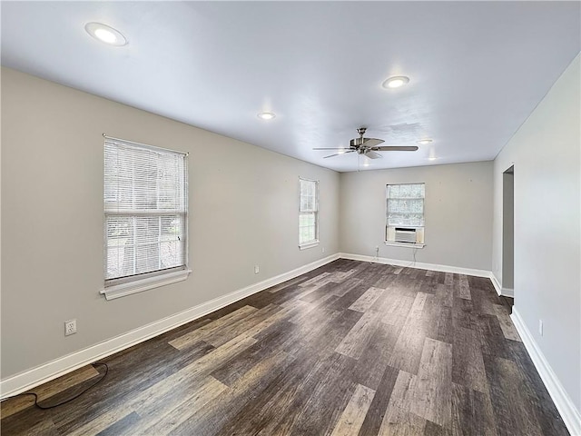 spare room featuring dark hardwood / wood-style floors, ceiling fan, and cooling unit