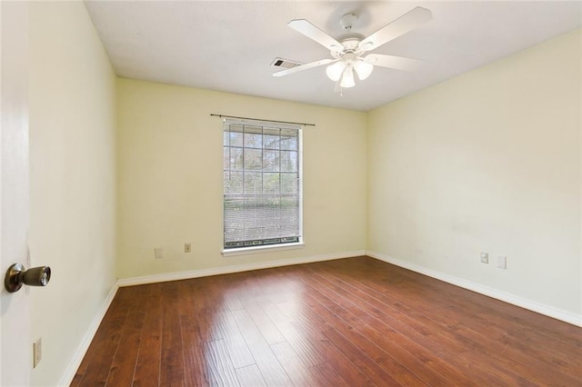 unfurnished room with dark hardwood / wood-style flooring and ceiling fan