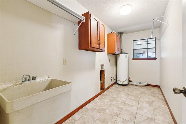 clothes washing area featuring cabinets, gas water heater, sink, a textured ceiling, and hookup for an electric dryer