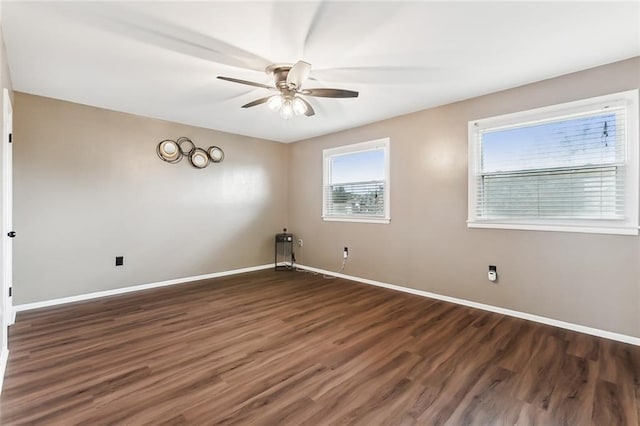 unfurnished room with ceiling fan and dark wood-type flooring