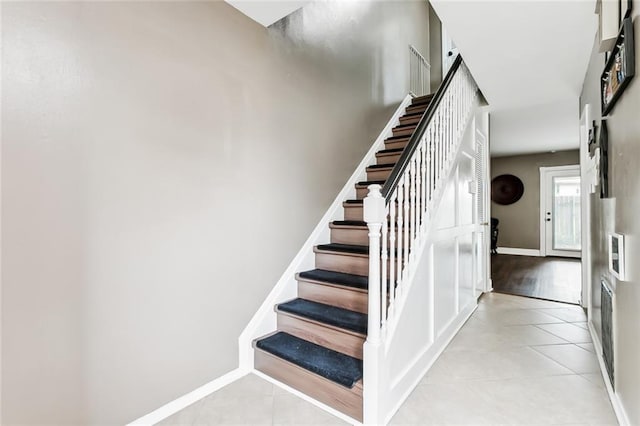 staircase with tile patterned floors