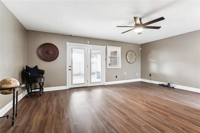 unfurnished room with ceiling fan and dark wood-type flooring