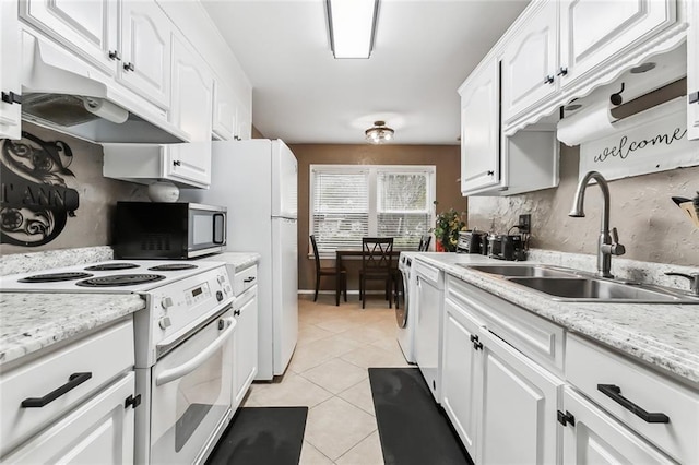 kitchen with white cabinets, white appliances, sink, and light tile patterned floors