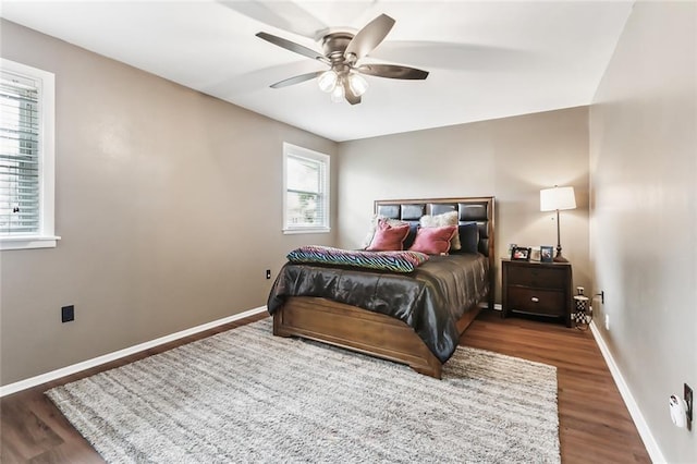 bedroom with dark hardwood / wood-style flooring and ceiling fan