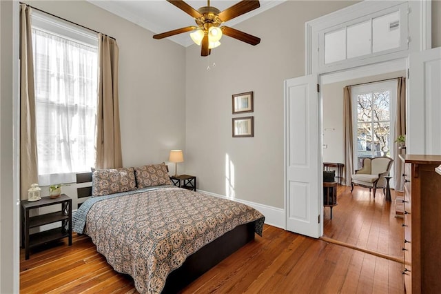 bedroom with ceiling fan and light hardwood / wood-style floors